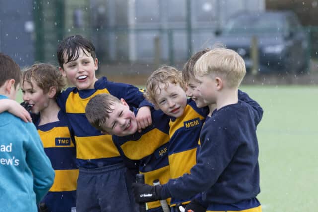 Cranleigh prep students in the hockey team huddling together as a group