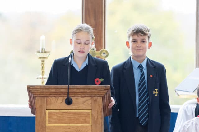 Cranleigh prep school's head boy and head girl reading during the Cranleigh prep school remembrance service