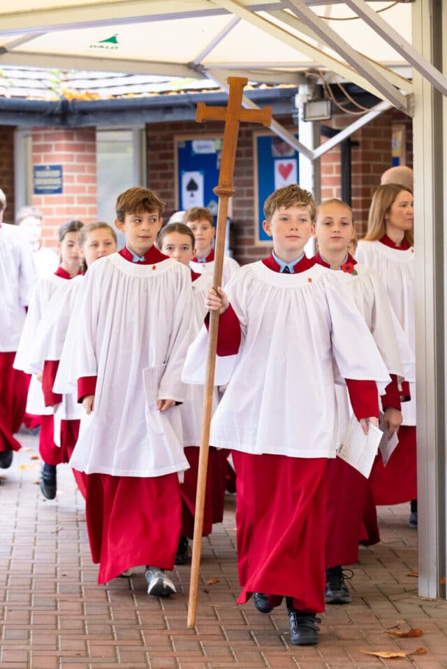 Cranleigh prep school students wearing traditional red gowns for the Cranleigh prep school remembrance service