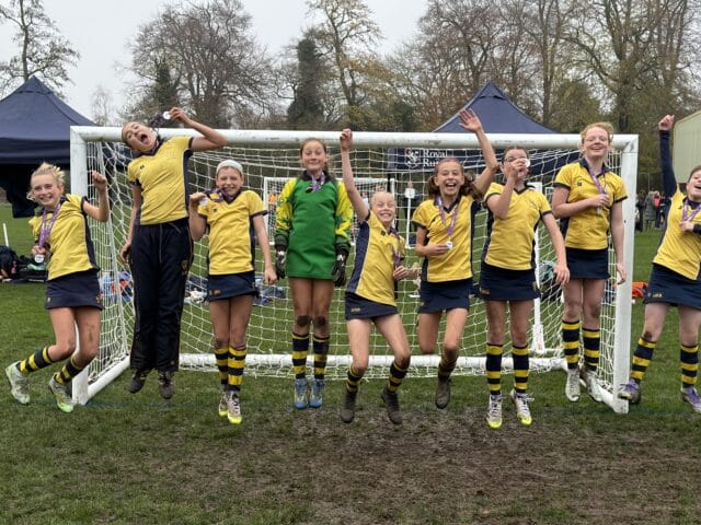 Cranleigh Prep U15 girls team posing at football game at IAPS