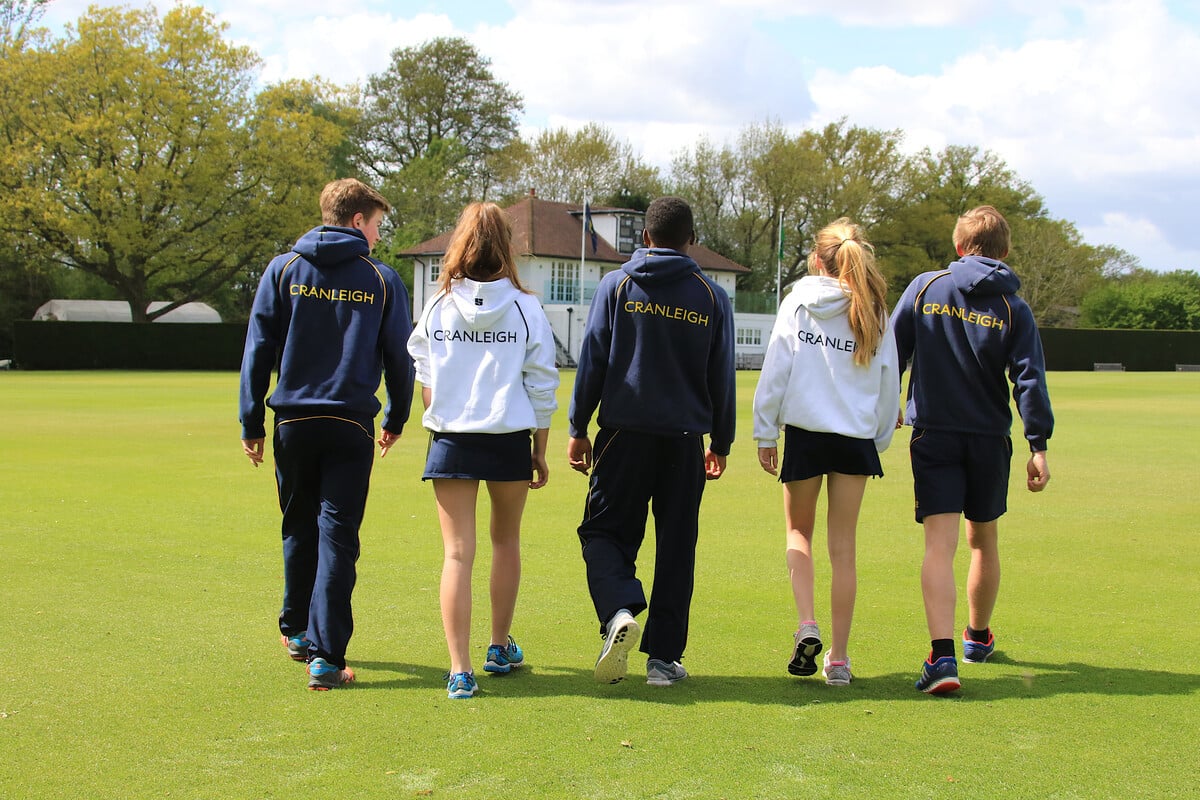 Cranleigh students walking on cricket pitch